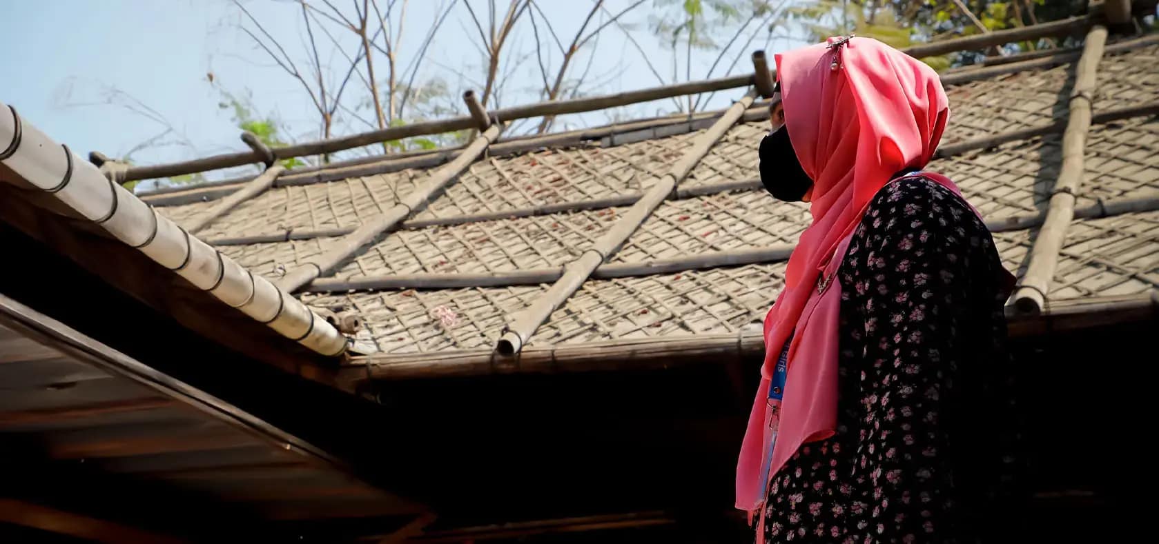 A Gender Volunteer stands with determination in the Women’s Market in Camp 5,